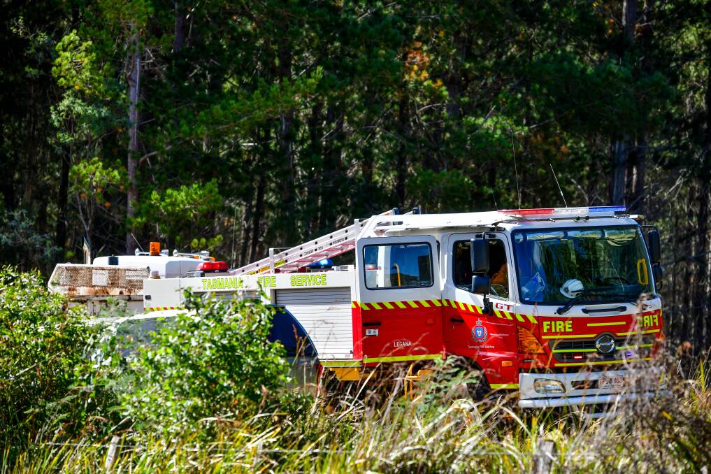An advice level bushfire near Exeter continued to burn on Monday afternoon with 15 TFS vehicles, including helicopters, in attendance battling the blaze. Picture: Scott Gelston.