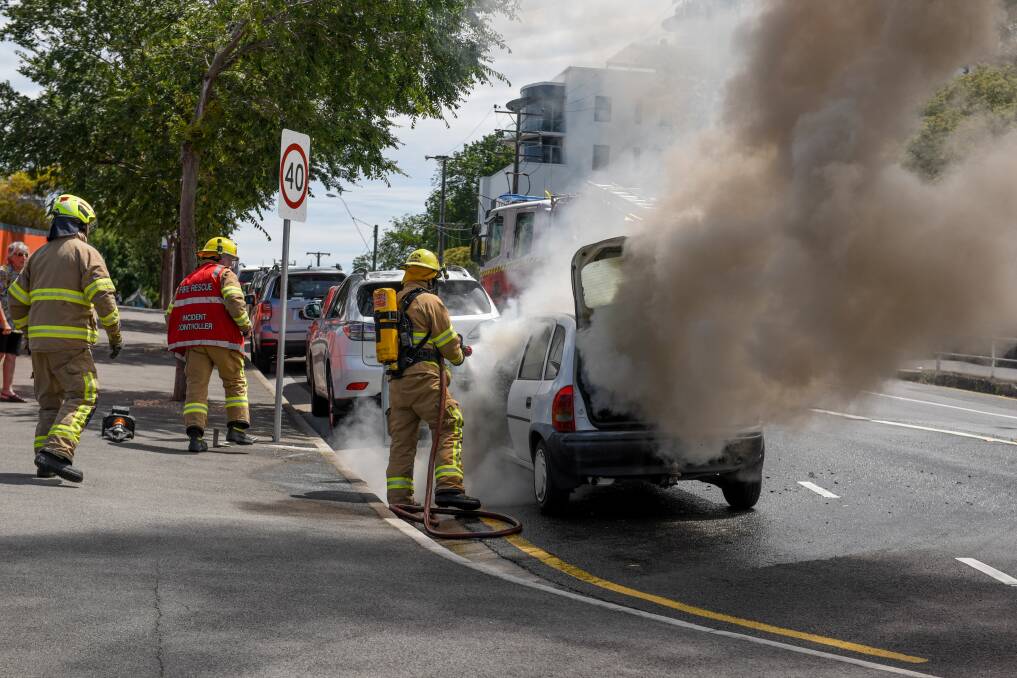 A Holden Barina, is extinguished by Firefighters near the roundabout of Charles Street and Howick Street. Picture: Paul Scambler 