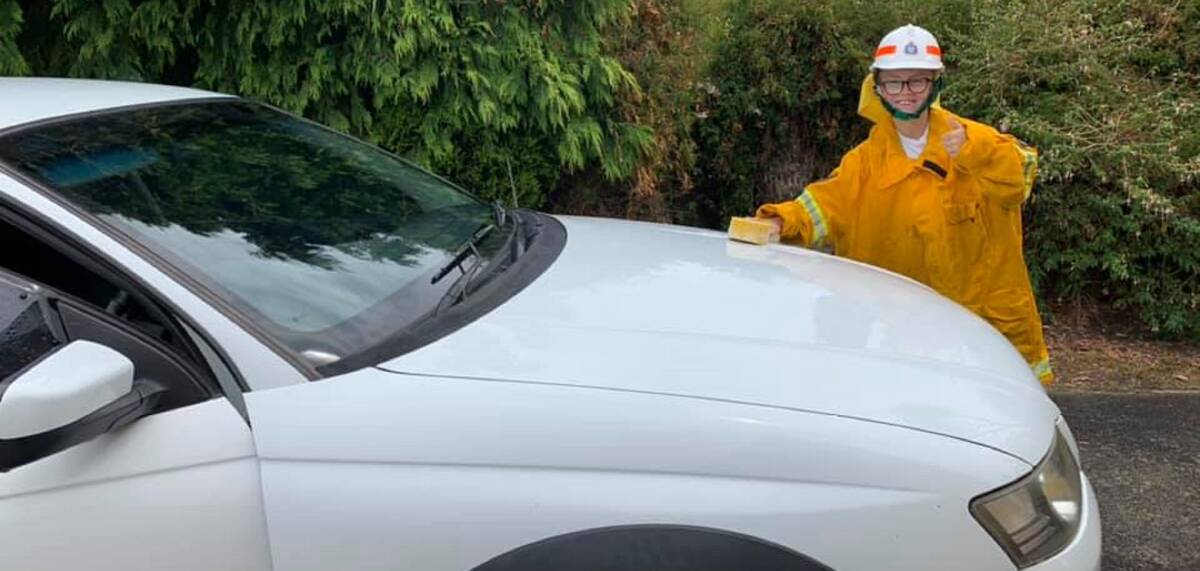 Great effort: Oliver Wallace, 9, washing cars to help bushfire appeals on the mainland. Pictures: Supplied