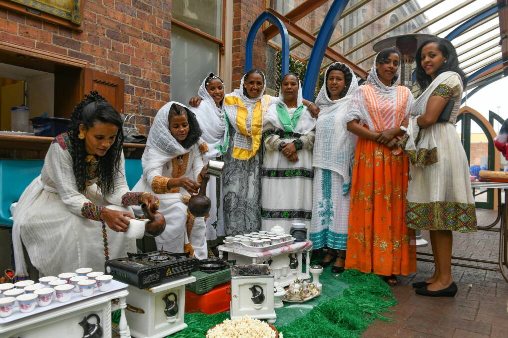 Coffee clarity: Tsige Mengesteab and Saba Gebrihewet make the coffee, during the Eritrean & Ethiopan Coffee ceremony at the Pilgrim Uniting Church. Picture: Paul Scambler