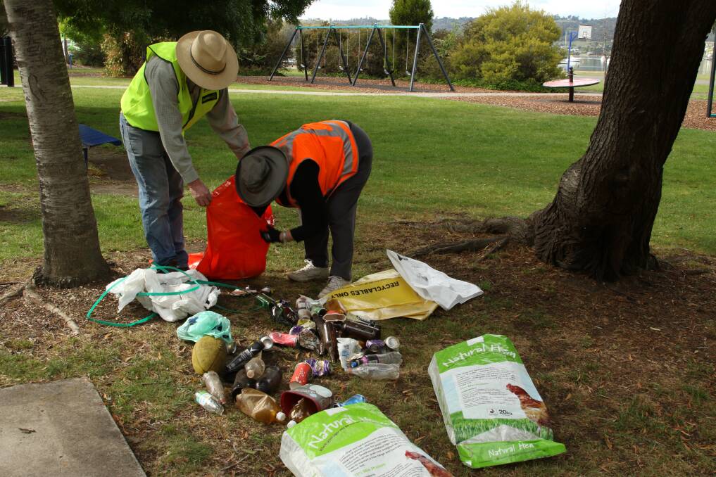 Combing: Members of West Tamar Landcare separating litter at the Gravelly Beach clean up. Picture: supplied
