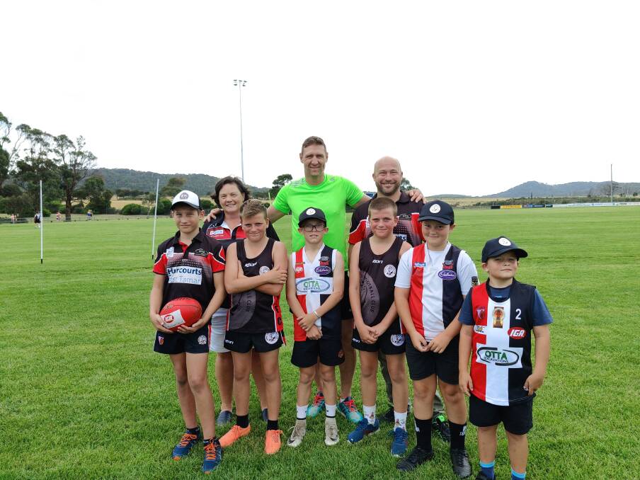 TOGETHER: Saints senior president Lynette Burt, Jay Schulz, Shane [back] and Billy Power, Jack and Henry Lindfors, Axle ansd Seth Sturzaker, with Zay Widdowson [front]. Picture: Harry Murtough