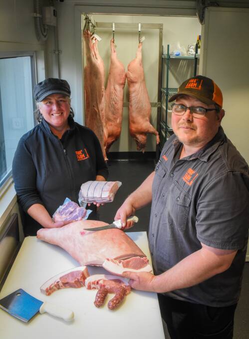 Pork it: Fork It Farm co-owners Kim and Daniel Croker at Lebrina slicing their pork. Picture: Paul Scambler