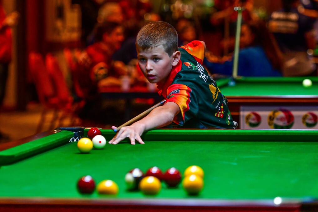 Tasmanian under-12 Blake Riley lines up the cue ball. 