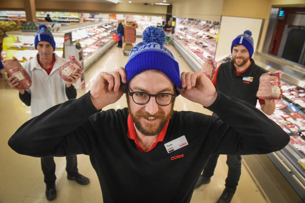 Big freeze: Coles Kings Meadows Store support Manager Tom McNamara pulls on the MND beanie with meat manager Darren Hine and Dry Goods Manager Mackenzie Barker. Picture: Paul Scambler