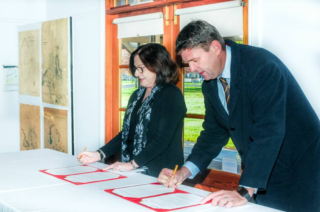 UTAS Provost Professor Jane Long and Hawthorn CEO Justin Reeves sign deal. Picture: Neil Richardson