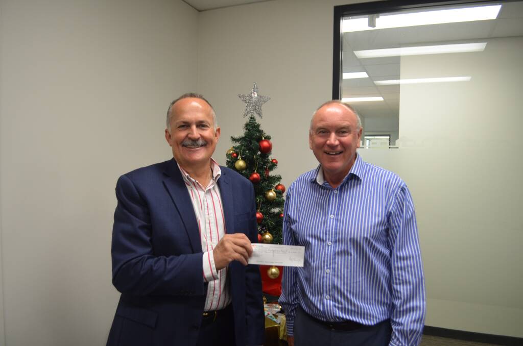 Generosity: Eric Anderson and Phillip Bushby with a cheque for $3,000. Picture: Harry Murtough