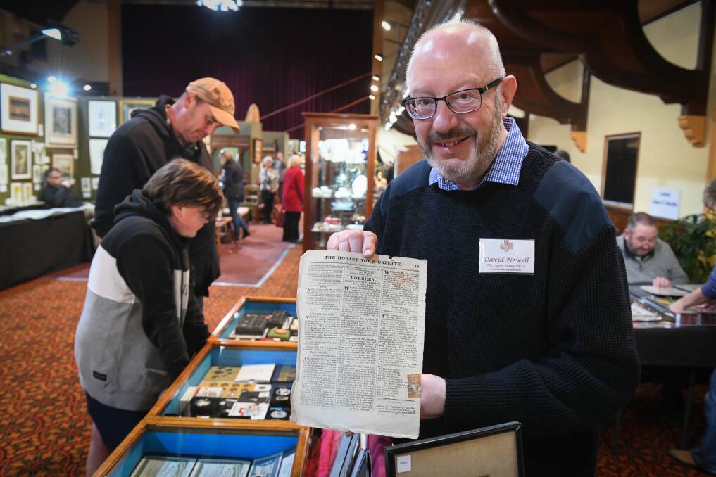 Timestamp: Peter Newell of The Coin and stamp place, Hobart with a July 12, 1828 Hobart Town Gazette, with the tax stamp on the front page. Picture: Paul Scambler