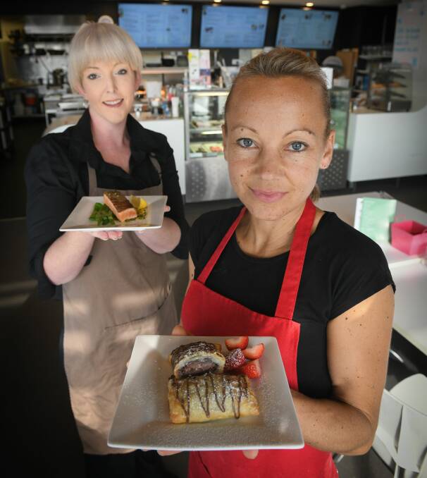Sugar sensations: Lucy Millwood holds a Nutella filled chocolate ravioli and Selina Bell with the Atlantic salmon in white chocolate sauce Picture: Paul Scambler