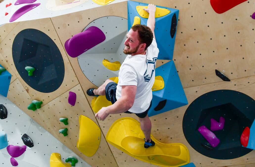 Hang ten: BetaPark owner Tommy Krauss testing out the bouldering walls at the new rock climbing gym at Invermay. Picture: Neil Richardson