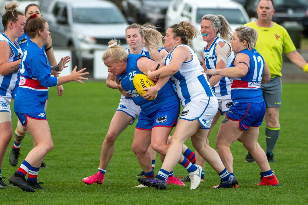BATTLE: South Launceston's Kate Child pushes through Deloraines' Chloe Perry among a group of Kangaroos at Youngtown Oval. Picture: Paul Scambler