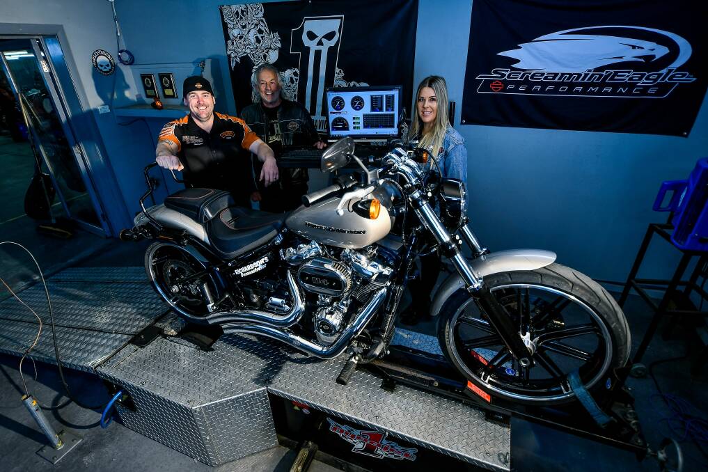 Heavy metal: Technician Adam Palmer, owner Simon Hrycyszyn and Lindelle Banks with a 2018 Harley Davidson Breakout. Picture: Scott Gelston