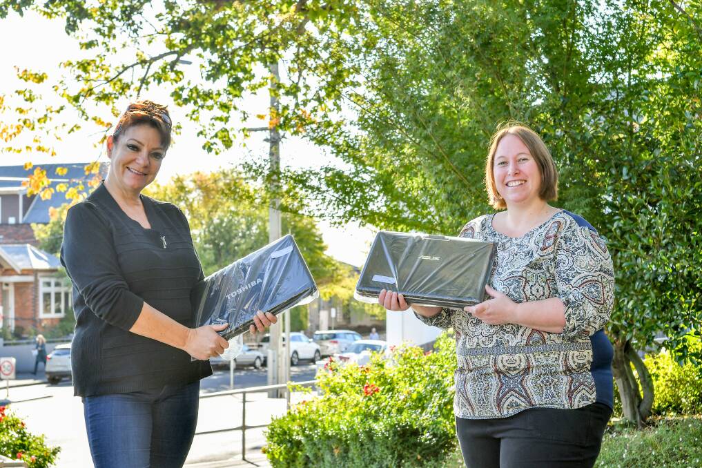 Giving: Laptops for Children in Launceston Organiser Shelley Foale and laptop recipient Rachel Clarke. Picture: Scott Gelston