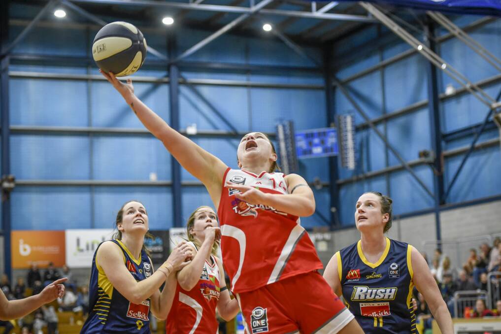 LEAPING: Mariah Payne goes in for the lay-up as sisters Alicia and Keely Froling look on. Picture: Craig George
