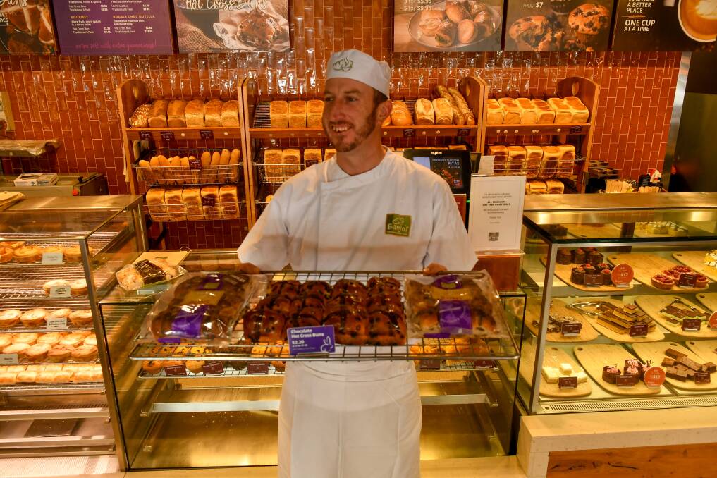 Crossed: Banjo's Launceston production manager Josh Lawrence with a tray of hot cross buns. Picture: Scott Gelston