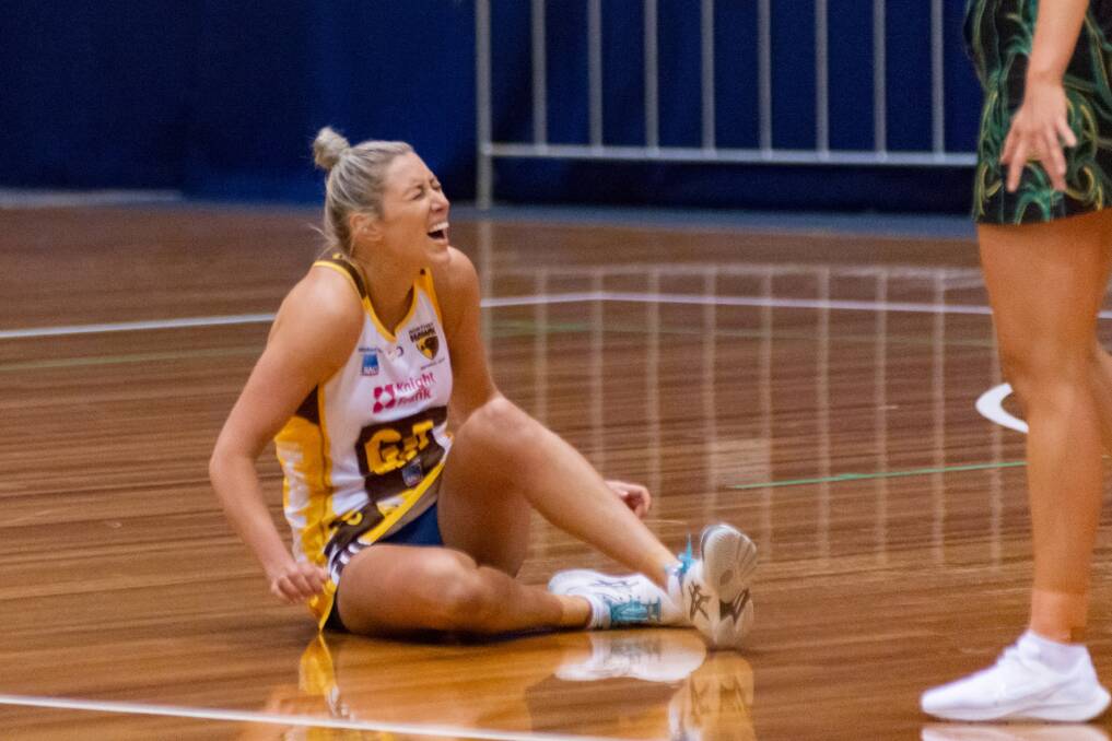 RUPTURE: Danni Pickett moments after rupturing her Achilles against the Cavs. Picture: Phillip Biggs