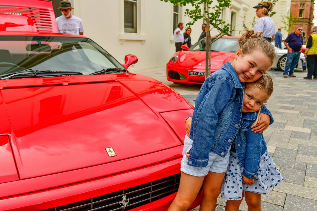 Bright smiles: Maggie, 6, and Lillie Chandler, 3, check out the cars. Pictures: Scott Gelston