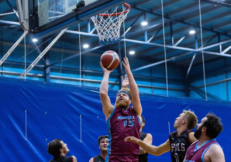 LEAPING: Rebels' Hugh King led his team with 21 points in their hard-fought win over the City Rockets. Picture: Matt Powell