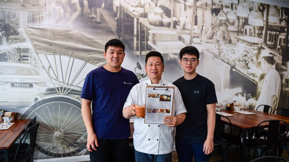 Boys in business: Malaycious' Li Hong Chew, David Lam and Jia Wei Tan with a hot cup of teh tarik, or Malaysian tea. Picture: Neil Richardson
