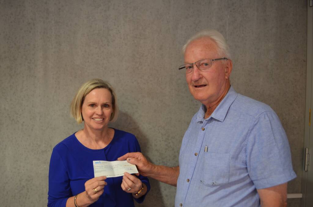 Helping the needy: The Examiner's Sandra Galvin receiving a cheque from Kenneth Hudson. Picture: Harry Murtough