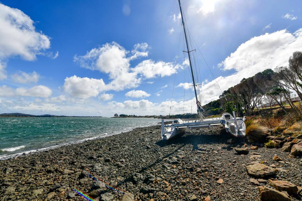 A catamaran washed up on the bank of The Tamar near the South George Town Esplanade during the recent stormy weather. Picture: Scott Gelston 