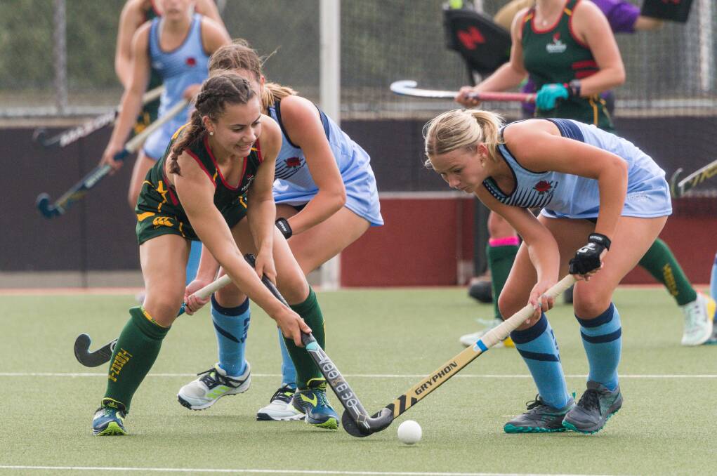 BATTLE: Tasmania's Zayna Jackson playing against NSW in the first round of the under 18 hockey national championships at St Leonards. Picture: Phillip Biggs