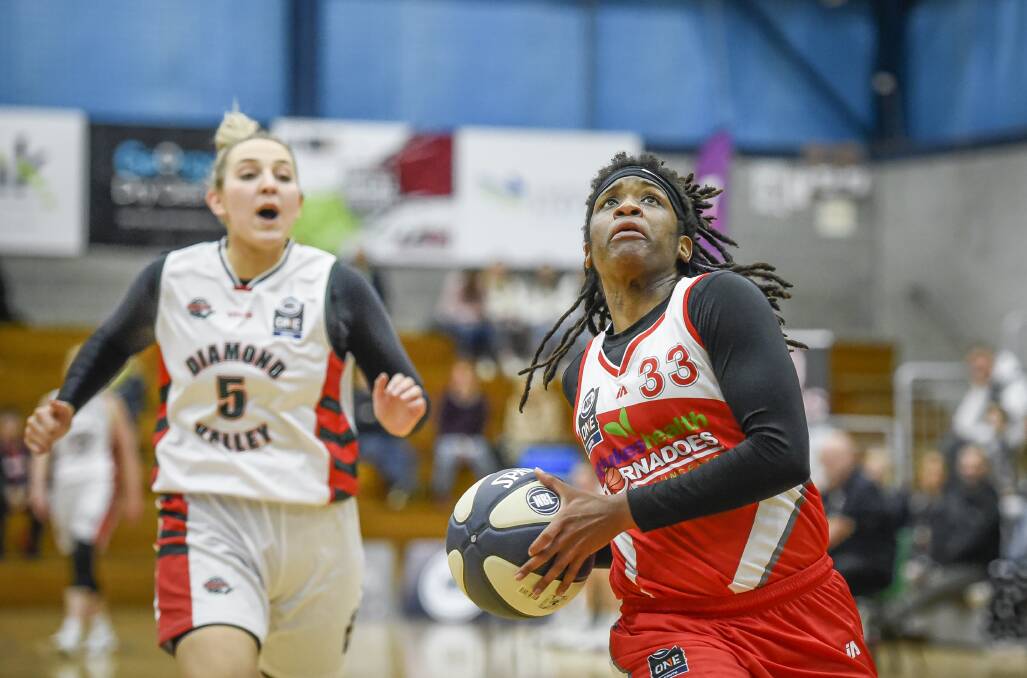 FOCUS: D'Asia Chambers eyes the rim. She's averaging nine points per game with the Tornadoes this season. Pictures: Craig George and Robert Spencer