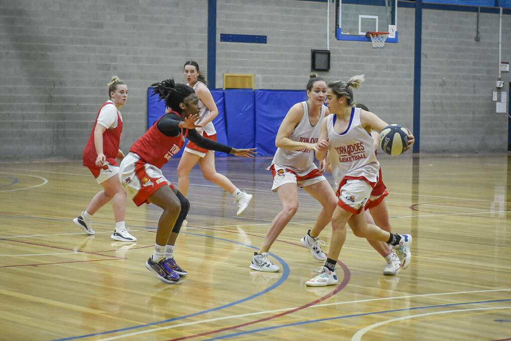 INCOMING: Tornadoes D'Asia Chambers, Aishah Anis and Keely Froling practising before this weekend's bout against Hobart. Picture: Craig George