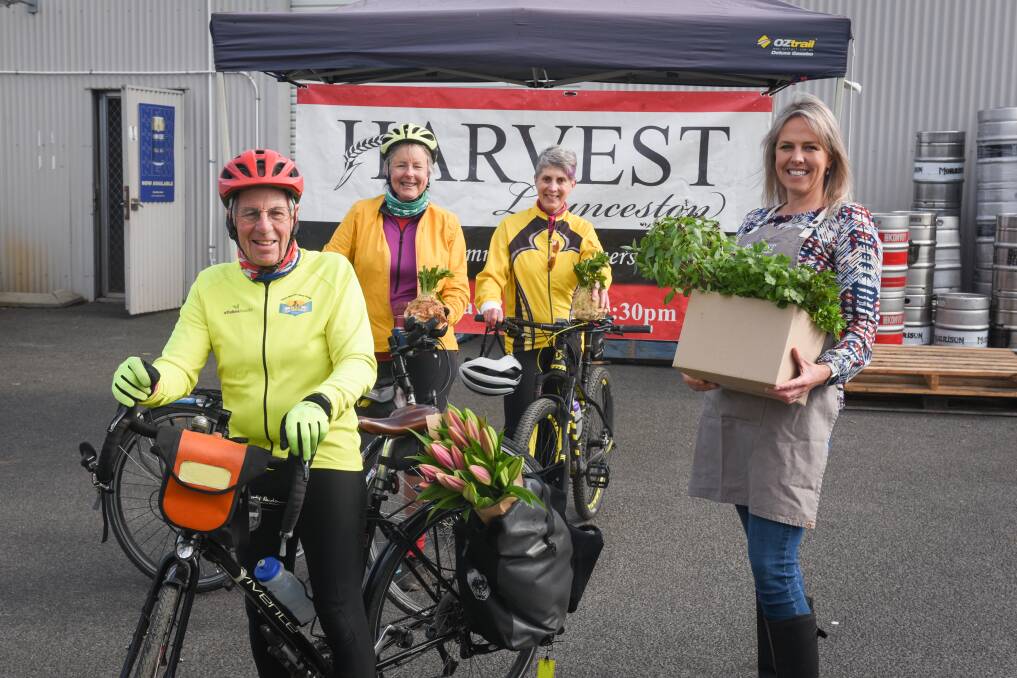 Ride-on: Harvest market manager Caroline Williamson with TBUG members Malcolm Cowan, Vicky Cowan and Marie Spencer are teaming up to deliver Mother's Day packages. Picture: Paul Scambler