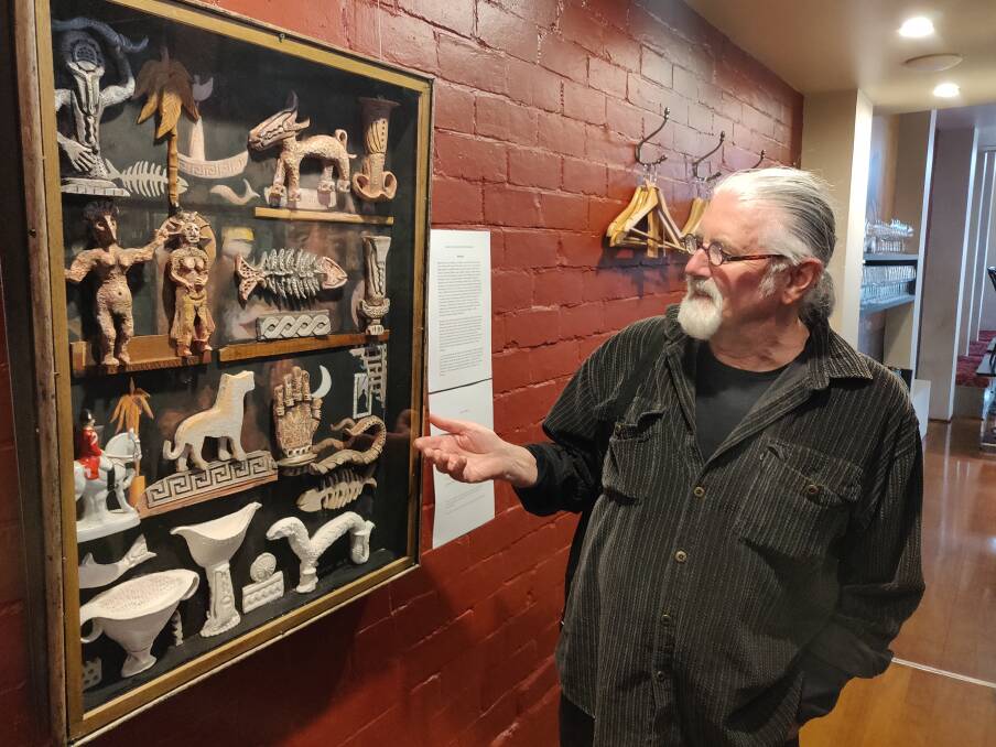 Rob Ikin and one of his works, Launguage, displayed at the Black Cow Bistro. Picture: Harry Murtough