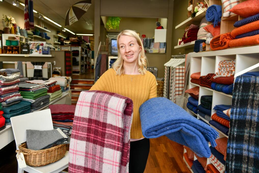Warm'n'fuzzy: Waverley Woollen Mills sales assistant Hannah Israel with their new recycled products. Picture: Scott Gelston