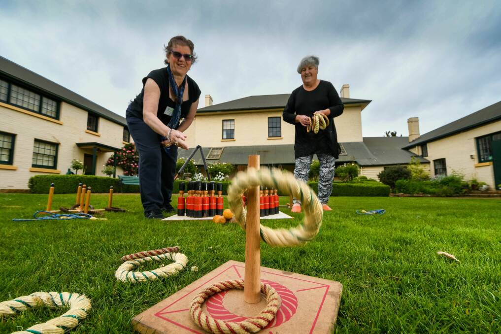 Old fashioned fun: Franklin House volunteers Kathy Rittman and Lucille Gee practicing their ring toss skills ahead of the Family Fun Day. Picture: Phillip Biggs