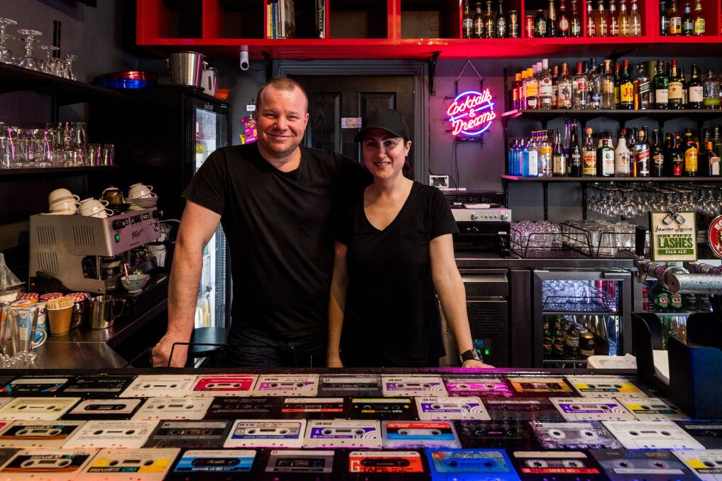 Retro: the Arcade Bar co-owners Shylie Woods and Dr Brad Goldsmith behind a 15kg resin bar housing old cassette tapes. Picture: Phillip Biggs