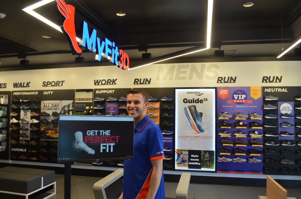 Athlete's Foot sales assistant Cameron Towns using the MyFit machine.