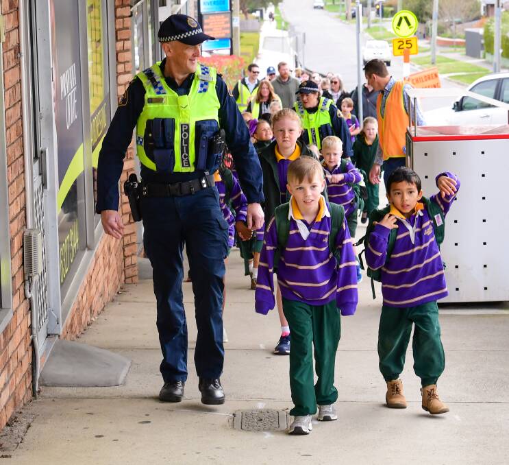 Wonder walk: First Class Constable John leads the walk to school with St Anthony's pupils Austin Holloway and Adarsh Pathak. Picture: Neil Richardson