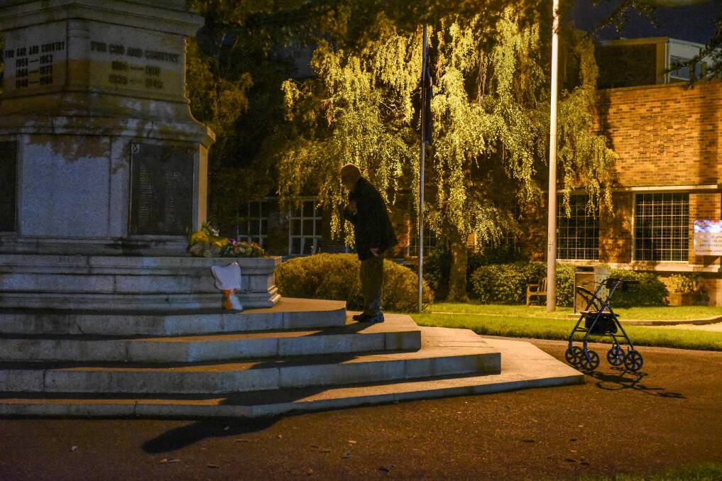 The colour version, 25th April 2020: All alone, Private Francis Dring of 5th RAR of Launceston, pays his repecs at the Launceston Cenotaph, during the Covid-19 lockdown.