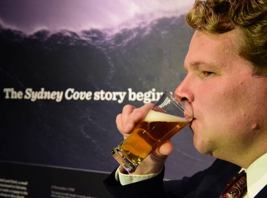 Taste test: QVMAG conservator David Thurrowgood samples the Preservation Ale, which has been brewed using 220-year-old yeast. Picture: PAUL SCAMBLER