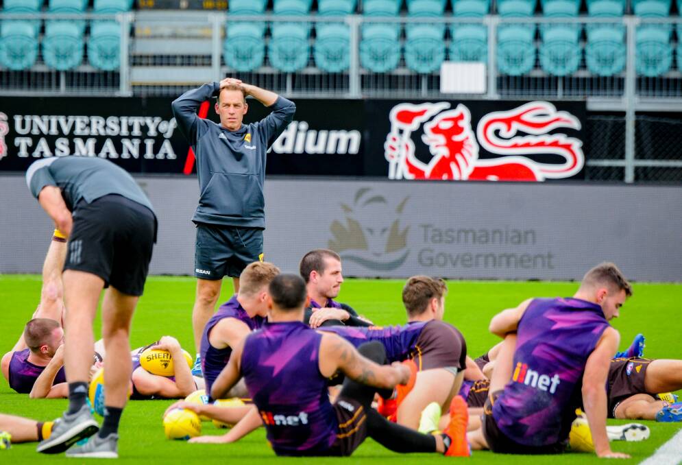 THINKER: Hawthorn four-time premiership coach Alastair Clarkson mulls over his players training.   