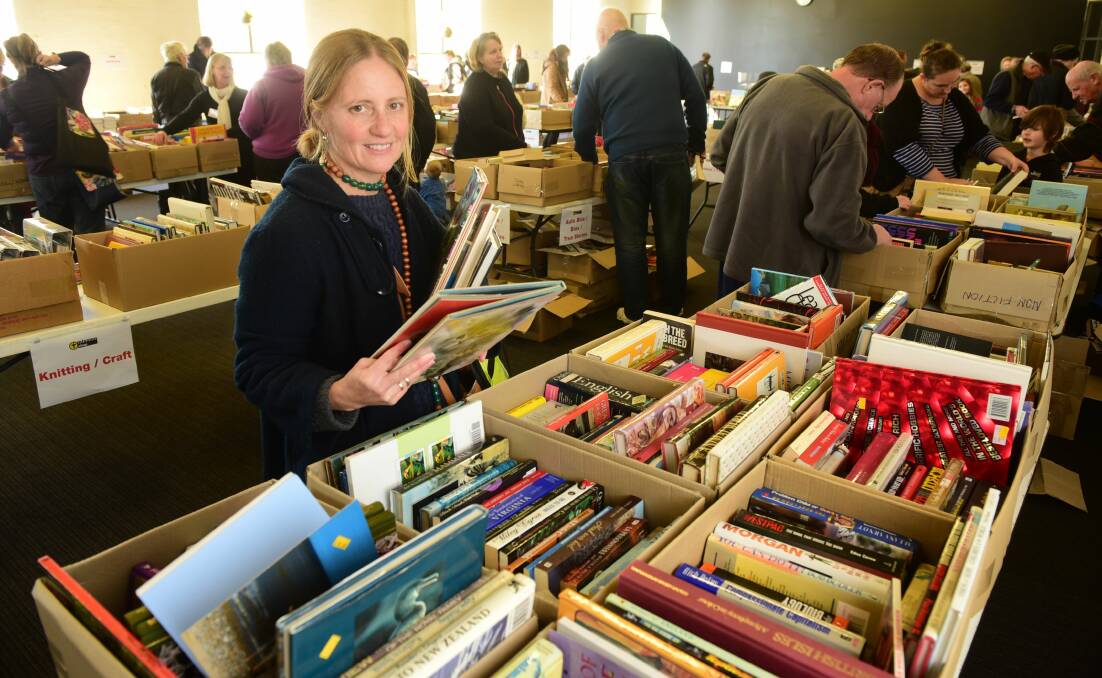 3/07/2015 Johanna Le Marchant of East Launceston with her arm load of books Door of Hope, City Mission Book fest.