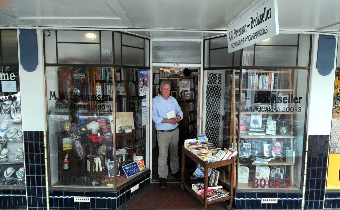 Former Examiner journalist, the legendary, Martin Stevenson who opened The Quadrant Mall Bookshop, stands in his doorway.