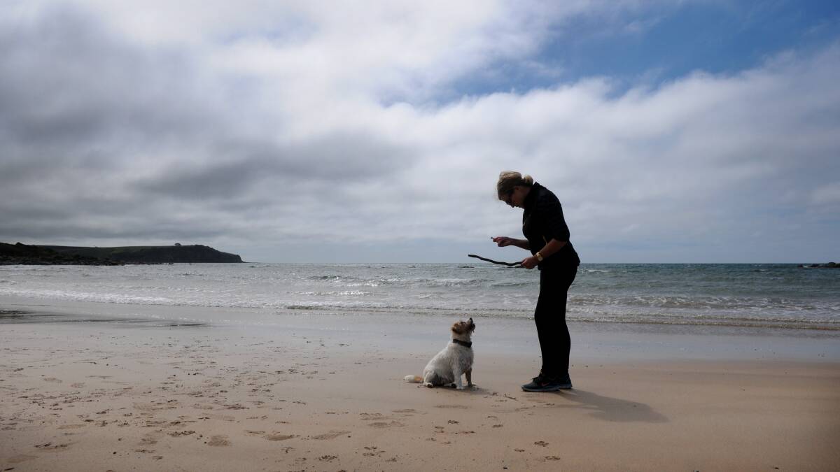 Kelly Rowell of Devonport and her dog "Polly" on the back beach at the Devonport Bluff.