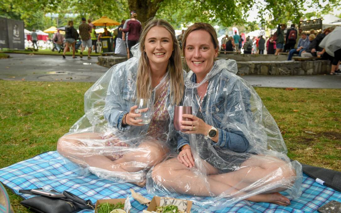Danielle Overend and Telina Moore of Burnie keeping dry. 
