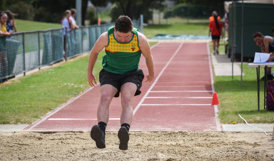 TOP LEAP: Campbell Town District High's Ryan Whitney stretches out in the boys' grade 10 triple jump.
