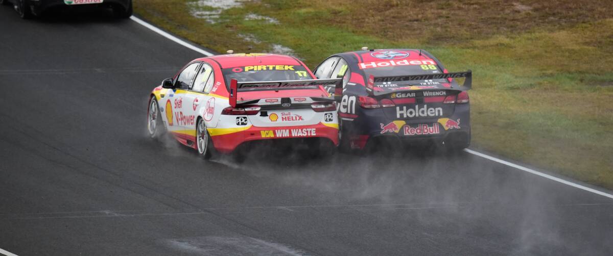 Jamie Whincup and Scott McLaughlin run door to door down the back straight.
