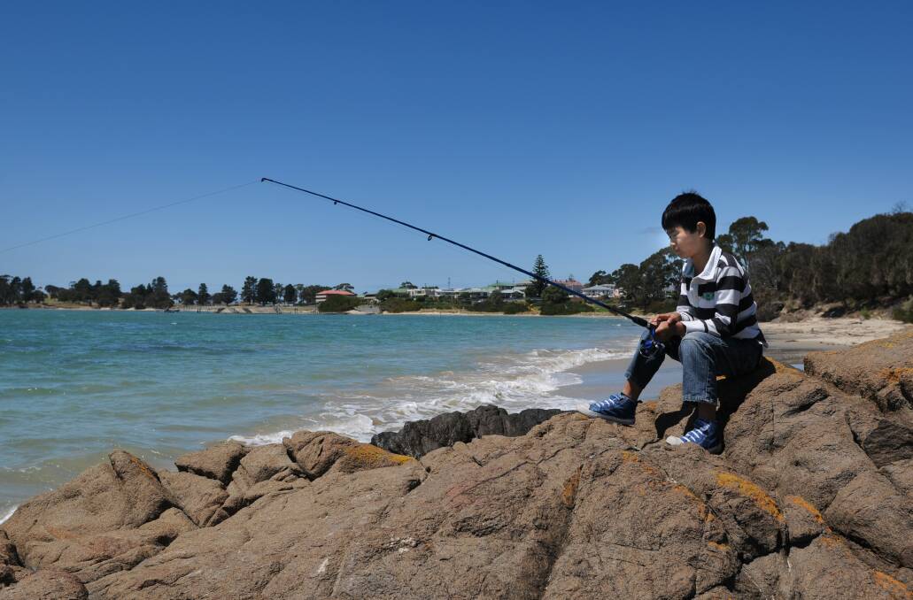 Tom Scambler sits fishing off the rocks at Jubilee Beach in Swansea where the Scambler family spent many a school holiday. 