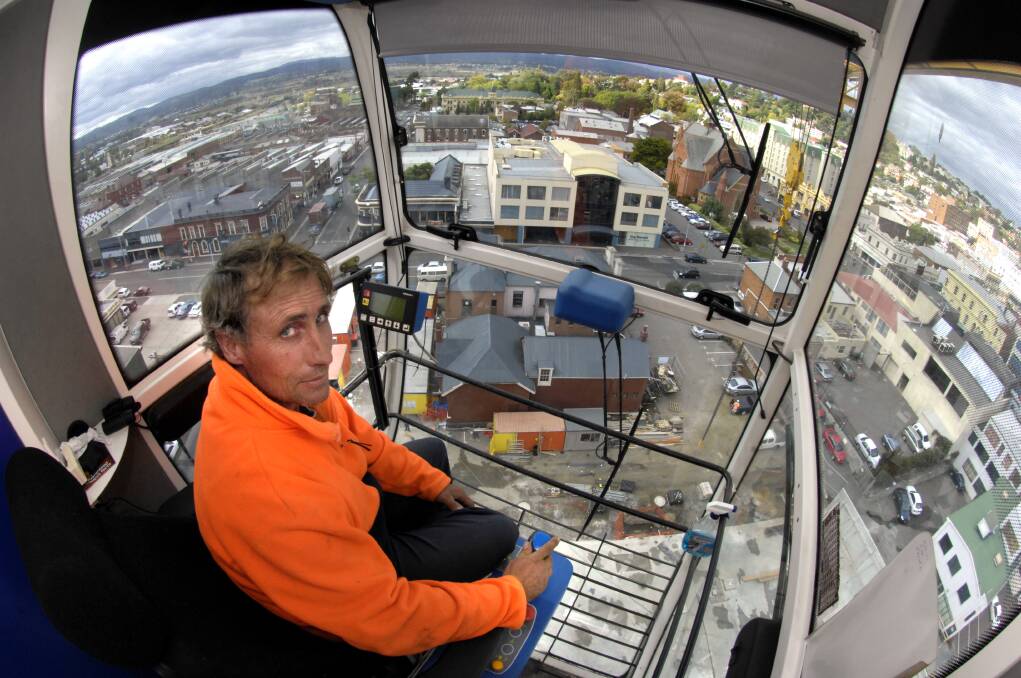 8-4-08 Scott Pilgrim, Crane operator , sits in his office 35 mtr above the building site at the Cimitiere House building site, looking towards George Street and which is now the home of the Examiner.