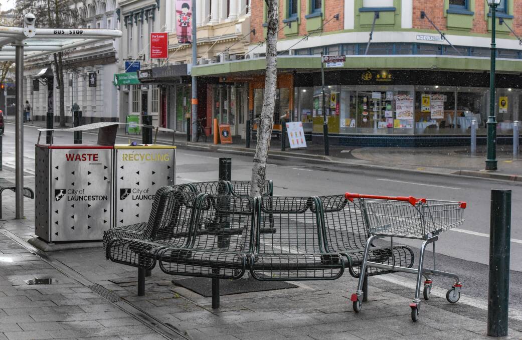 1:40:44 St John Street, Launceston with a stray supermarket trolley waiting at the bus stop. 