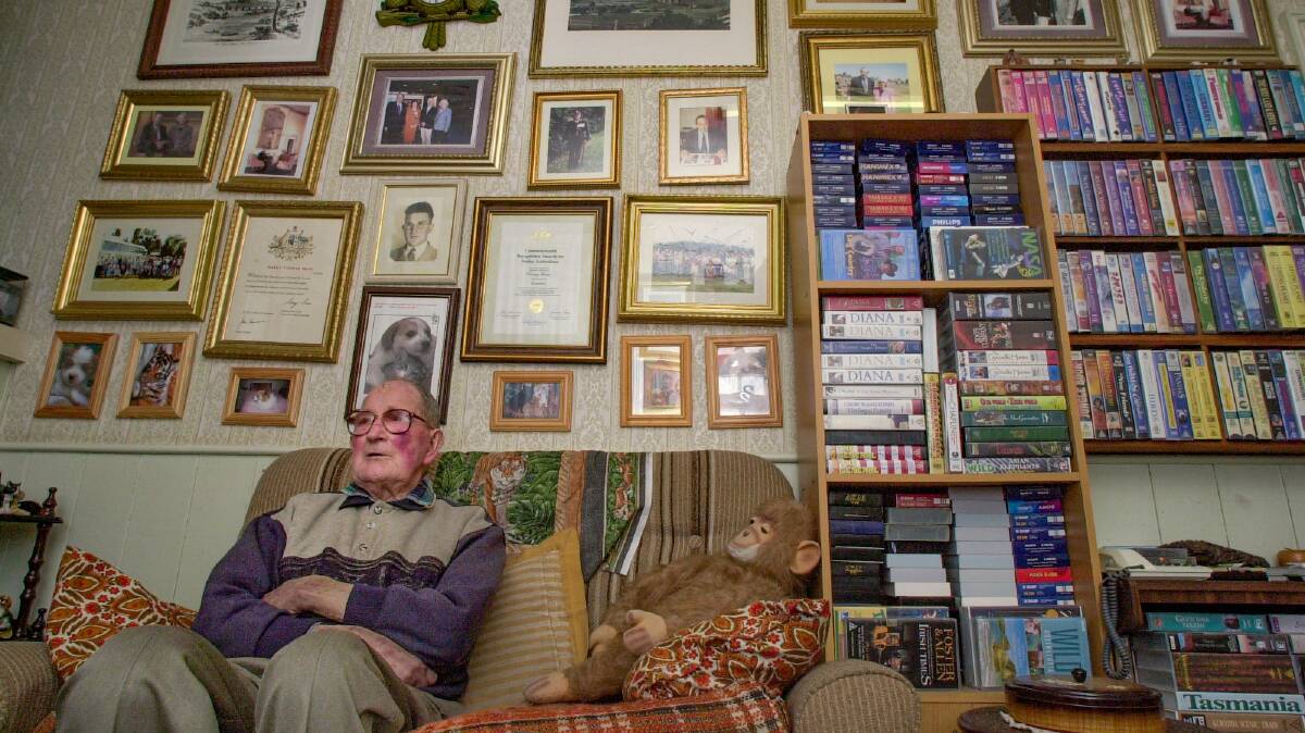 7/10/2004 HISTORIAN: Harry Bean in front of a wall of favourite pictures, photographs and certificates in his Perth home. 