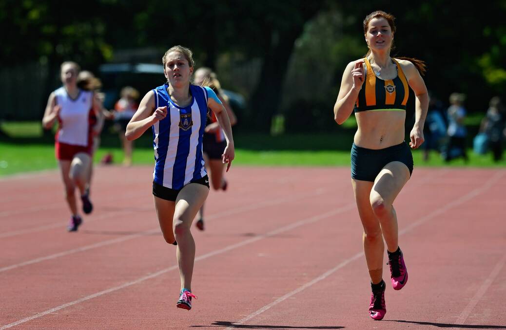 SPRINT FINISH: Launceston Grammar School runner Kysha Hill and St Patrick's College runner Sarah Ashlin finish off a race at the SATIS carnival. Pictures: Phil Biggs