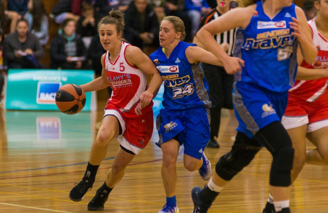 PRESSURE: Launceston Tornadoes captain Lauren Mansfield fights to keep control of the ball under close tagging by a Bendigo opponent. Picture: Phil Biggs